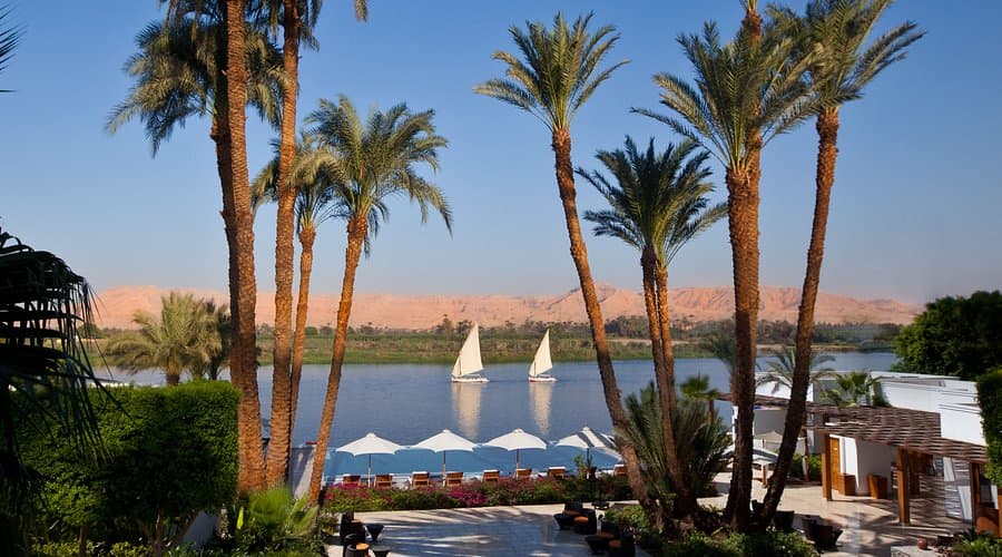 Views of the Nile with feluccas and the West Bank mountains