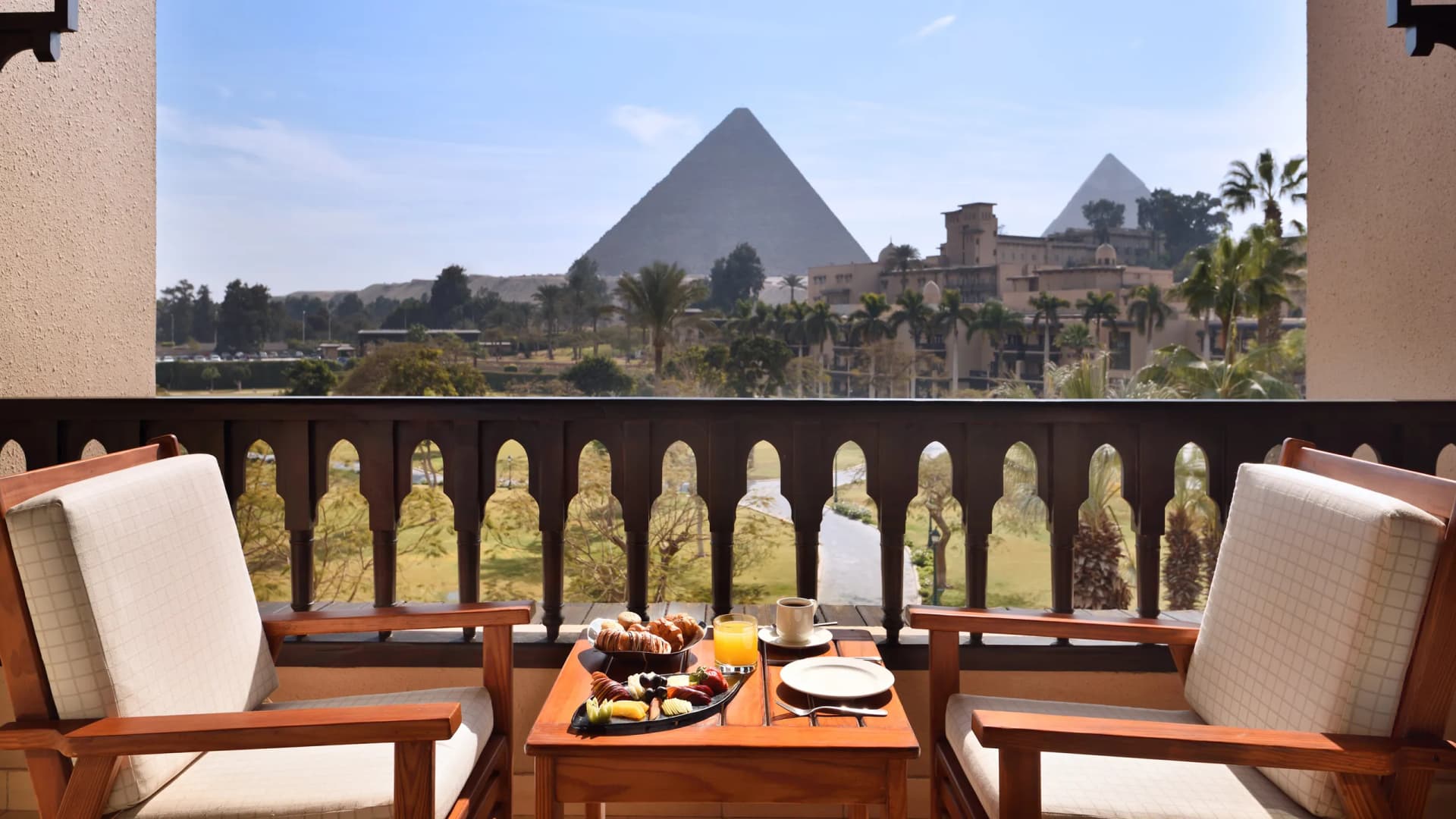 Breakfast on your private balcony overlooking the pyramids
