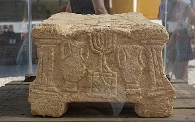The carved stone block from the Migdal Synagogue showing the seven-branched menorah, discovered in 2009.